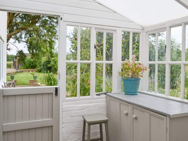 Garden room with lovely views over the garden | Walnut Tree House, Tilney St Lawrence, near Kings Lynn