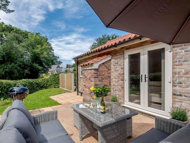 Main entrance and additional patio area | Woodcutters Cottage - Bray Holiday Cottages, Fulletby, near Horncastle