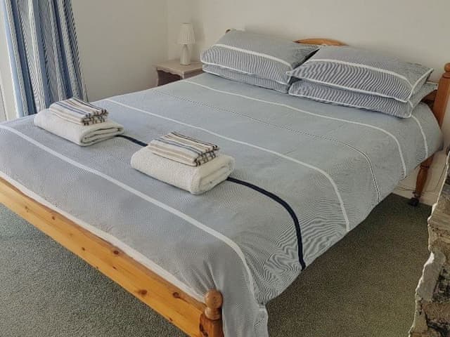 Double bedroom with double doors leading out onto the balcony with lovely river views | Middle Deck, Fowey