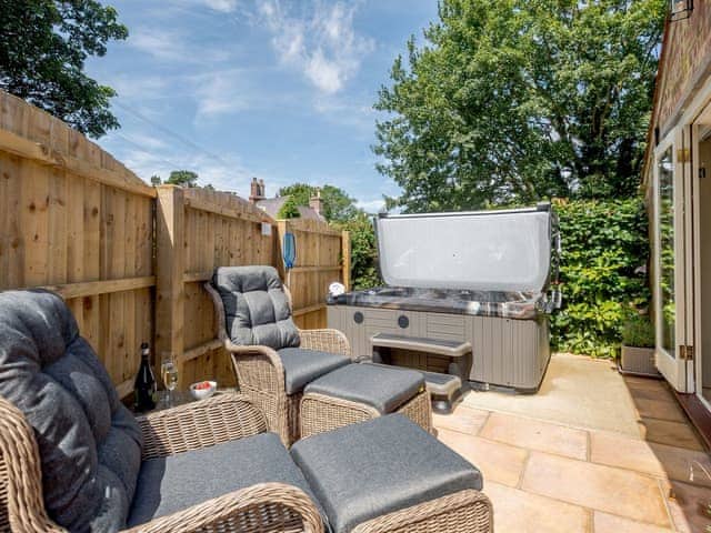 Delightful patio area with hot tub and outdoor furniture | The Chicken Coop - Bray Holiday Cottages, Fulletby, near Horncastle