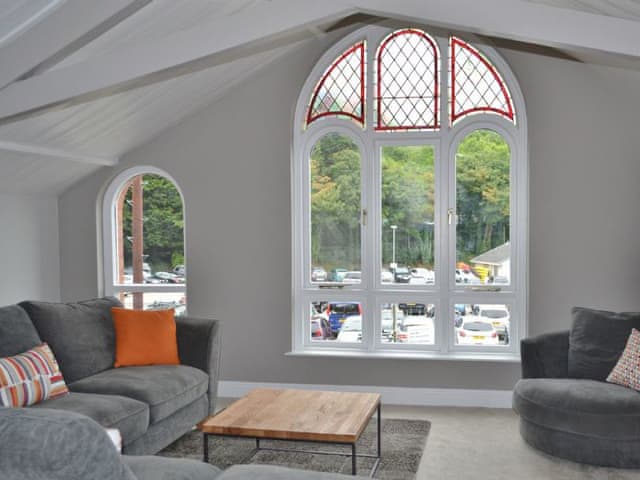 The huge floor to ceiling arched window in the lving area affords views of the river | St Monicas, Fowey