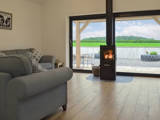 Wonderful living area with cosy wood burner | Taters Barn, Aikton, near Wigton
