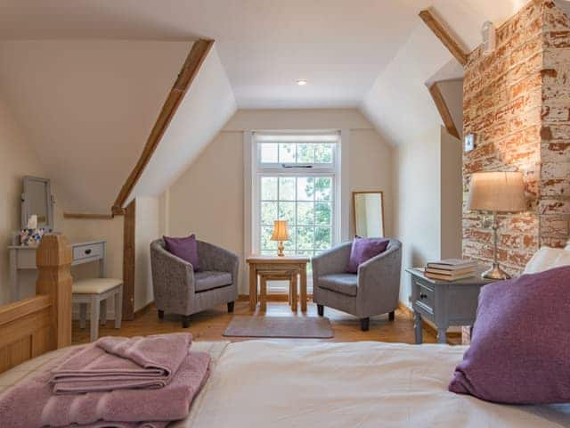 Seating area within double bedroom | The Coach House Stables, Hernhill