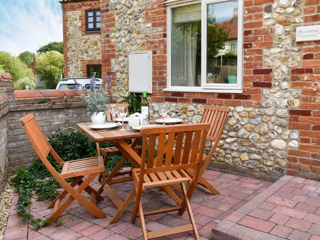 Small, enclosed, paved courtyard with garden furniture | Bluebell Cottage - Naturally Norfolk, Docking, near Hunstanton