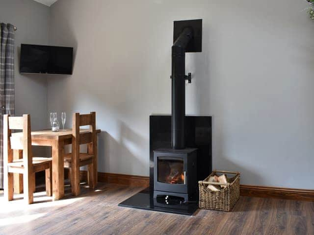 Modest dining area and wood burner | Poppy Lodge - Tavern Cottages, Newsham, near Richmond