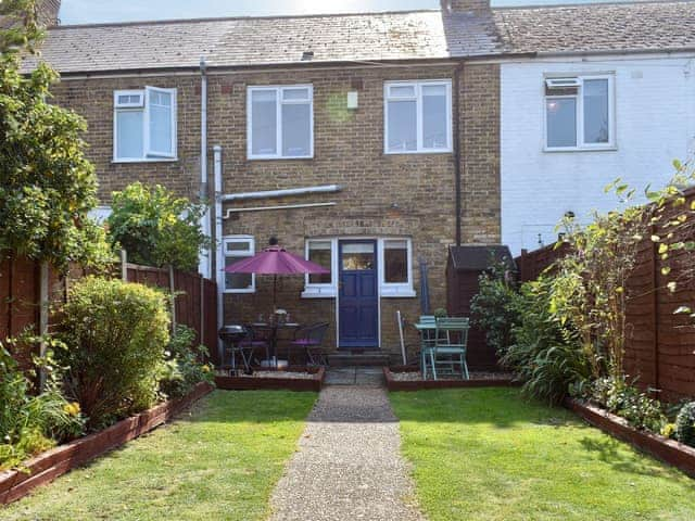 Enclosed garden with terrace and furniture | Shingle Cottage, Whistable