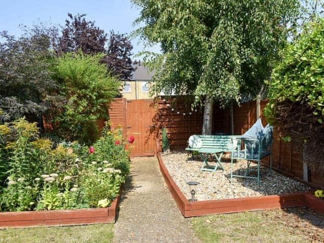 Enclosed garden with terrace and furniture | Shingle Cottage, Whistable