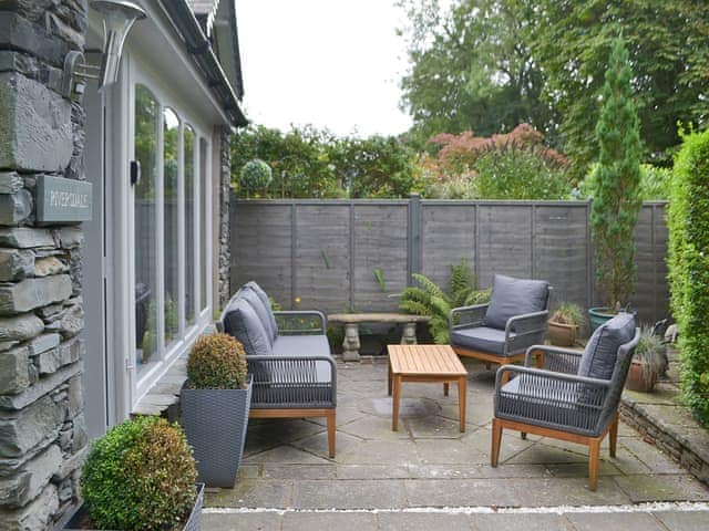 Geometrically paved patio area with furniture | Riversdale - Grange End Cottages, Grasmere