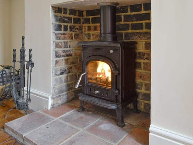 Warming wood burner within the dining room | Cats Cottage, Kessingland, near Lowestoft