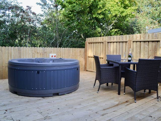 Relax and enjoy the private hot tub | Curlew Lodge - Wallace Lane Farm Cottages, Brocklebank, near Caldbeck and Uldale