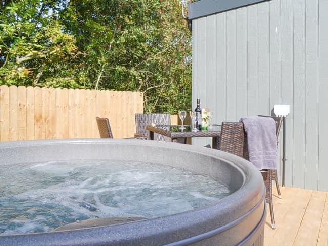 Decked area with hot tub and outdoor eating area | Lapwing - Wallace Lane Farm Cottages, Brocklebank, near Caldbeck and Uldale