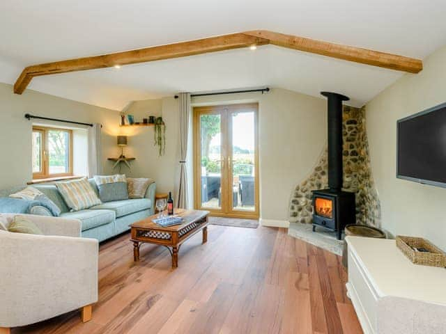 Tastefully furnished living area with woodburner | Stackyard Cottage, Skeyton, near North Walsham