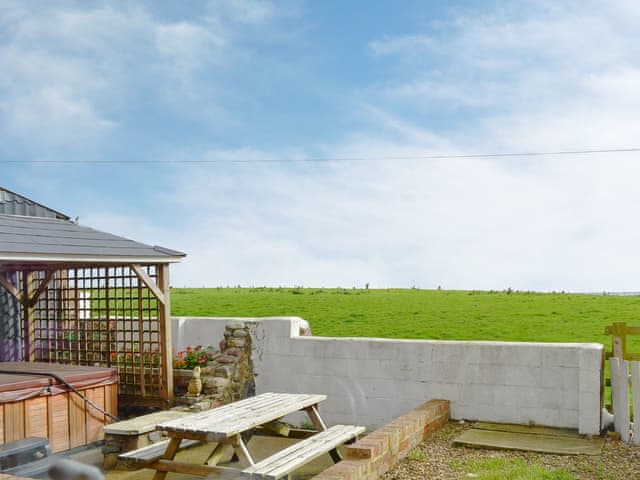 Garden area with hot tub and sea views | Old Low Farm Cottage, Aldbrough, near bridlington