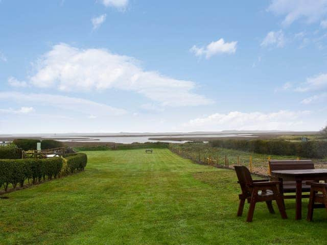 Large lawned garden with sitting-out area | Dale View - Sea Marsh Cottages, Brancaster Staithe, near Wells-next-the-Sea