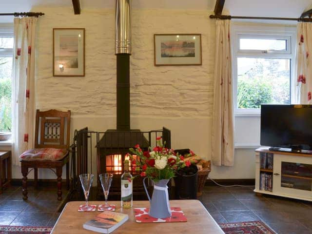 Cosy and warm living room with exposed stone wall | Trenay Barn Cottage, St Neot, near Liskeard