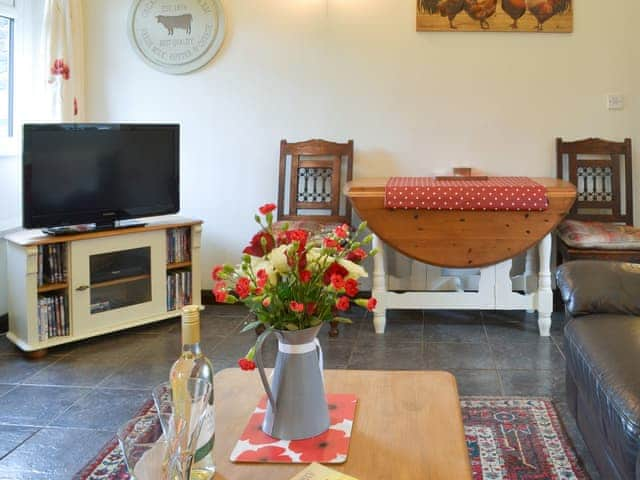 Tile-floored living area with intimate dining area | Trenay Barn Cottage, St Neot, near Liskeard