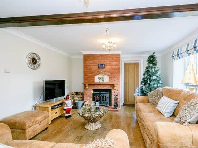 Beautifully presented living room with wood burner | Corner House, East Runton