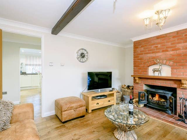 Beautifully presented living room with wood burner | Corner House, East Runton