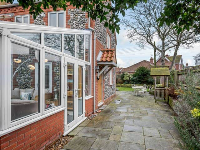 Large enclosed lawned garden with garden furniture | Corner House, East Runton