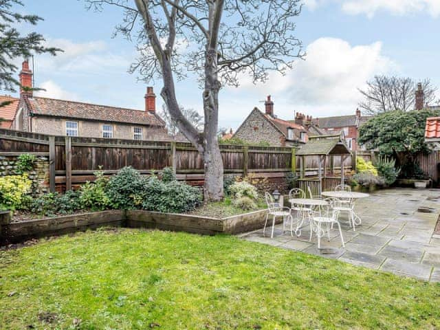 Large enclosed lawned garden with garden furniture | Corner House, East Runton