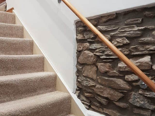 Staircase with exposed stonework and handrail | Lynton Cottage, Combe Martin