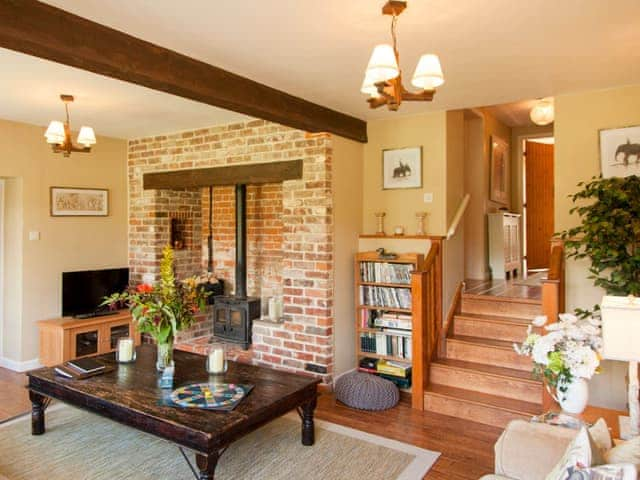 Comfortable living room with wood burning stove | The Hayloft - Marshwood Manor Cottages, Bettiscombe, near Lyme Regis