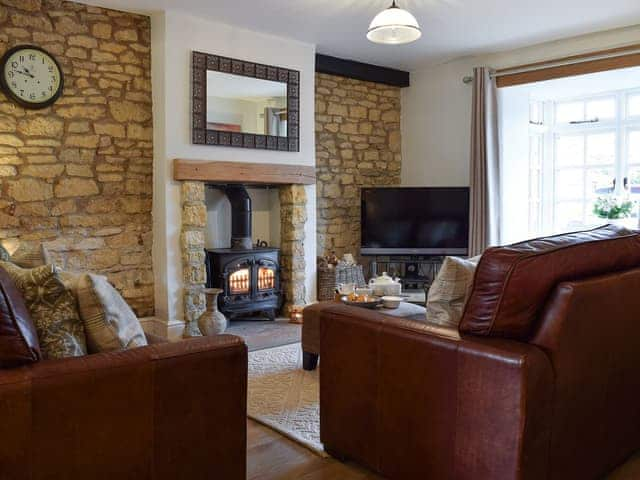 Cosy living room with wood burner | Spring Cottage, Bourton-on-the-Water