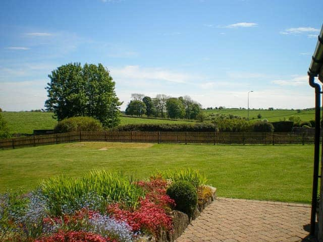 Spacious garden with patio and furniture | Meadowside Cottage, Calton Moor, near Ashbourne