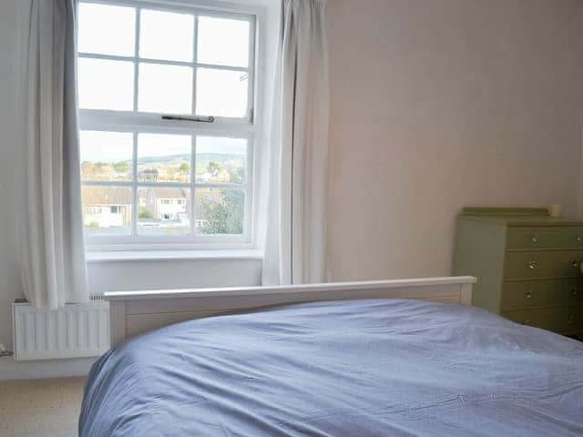 Charming bedroom with sash windows affording a lovely view | Honeysuckle Cottage, Watchet