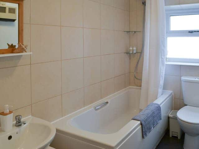 Tiled bathroom with shower over the bath | Broughs House, North Broomhill, near Amble