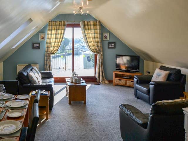 Living room with doors leading to veranda | Solace - Simpson&rsquo;s Boatyard, Stalham