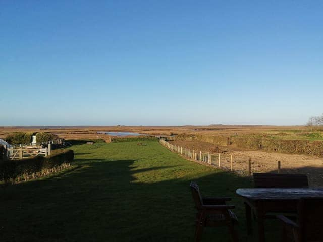 Far reaching views over the garden and slat marsh beyond | Dale View, Vista Cottage - Sea Marsh Cottages, Brancaster Staithe, near Wells-next-the-Sea