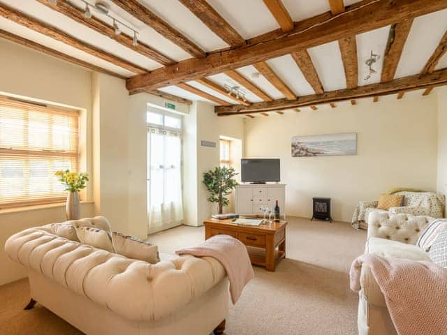 Charming living area with beamed ceiling | Laurel Barn, Tacolneston, near Wymondham