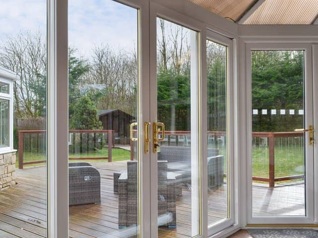 Second conservatory area with French doors to the patio | West Fells Cottage, Rowrah, near Frizington