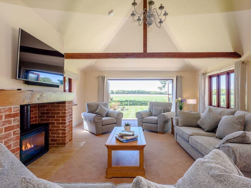 Spacious living room with wonderful rural views | Moat Lodge - Piggyback Barns, Sculthorpe, Fakenham