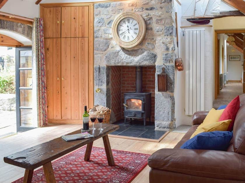 Lovely living room with feature fireplace | The Byre - Lyserry Barns, Bosherston, near Pembroke