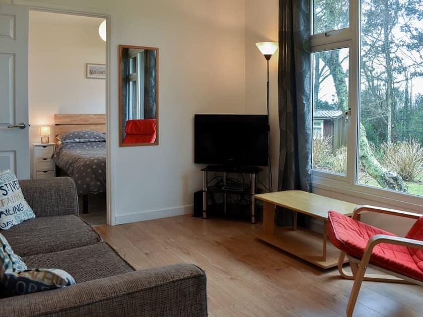 Comfortable living area and adjacent bedroom | Chalet 5 - Mount Hawke Holiday Bungalows, Mount Hawke, near Redruth