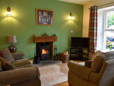 Cosy living area with wood burner | Coach House Cottage, Buckden