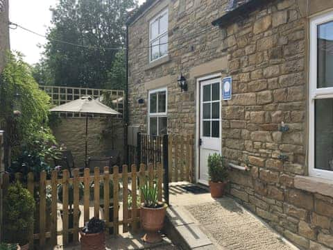 Exterior with access ramp and fenced sitting area | Fawn Lea Cottage, Staindrop, near Barnard Castle