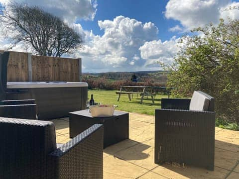 Patio area with hot tub | The Coach House, Trelawnyd, near Prestatyn