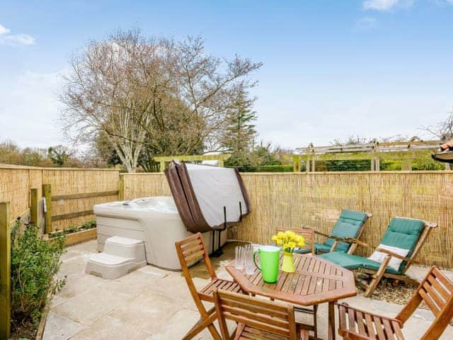 Spacious patio area with hto tub | The Hayloft - Meadow Farm, Hickling