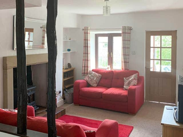 Cosy, beamed living room with wood burning stove | Rock Cottage, Crosthwaite