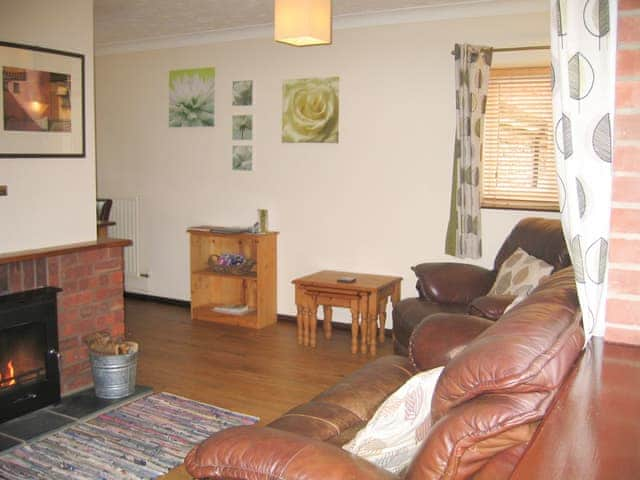 Welcoming living room with cosy wood burner | The Granary - White House Farm Holiday Cottages, Knapton, near North Walsham