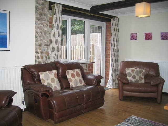 Welcoming living room with cosy wood burner | The Granary - White House Farm Holiday Cottages, Knapton, near North Walsham