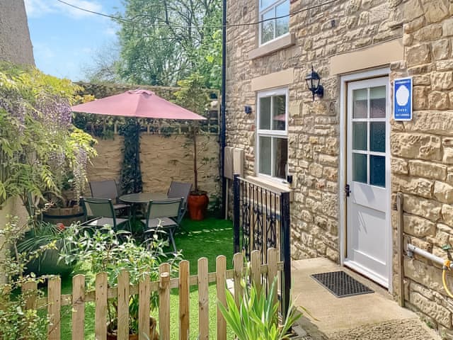 Exterior with access ramp and fenced sitting area | Fawn Lea Cottage, Staindrop, near Barnard Castle