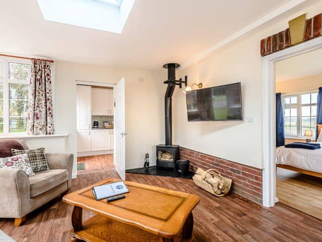 Welcoming living area with wood burner | White Oak Cottage, Hagworthingham, near Horncastle