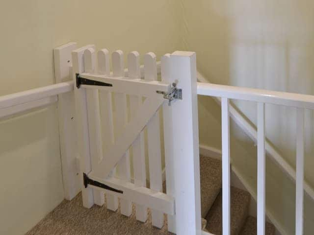 Safety gate at top of stairs | Hollyhock Cottage - Blakeney Quayside Cottages, Blakeney, near Holt