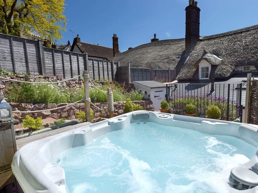 Relax in the sumptuous private hot tub | The Old Sweet Shop - Vicarage Road Holiday Cottages, Minehead