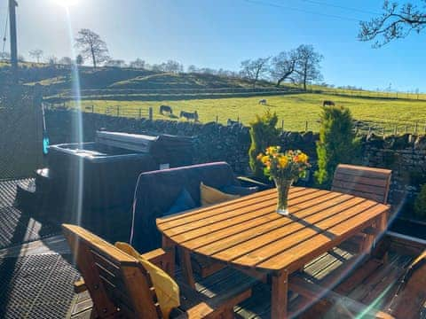 Decked patio area with seating and hot tub | Lily Rose Cottage, Gilsland, near Brampton