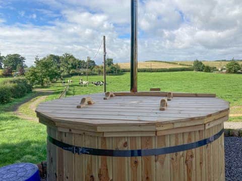 Wood fuel hot tub with views out towards the Moffat hills | Curlew Cottage, Lockerbie, near Moffat